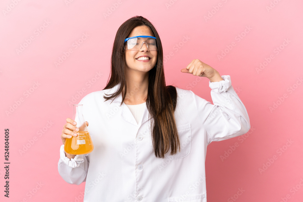 Young scientific girl over isolated pink background doing strong gesture Young scientific girl over isolated pink background doing strong gesture