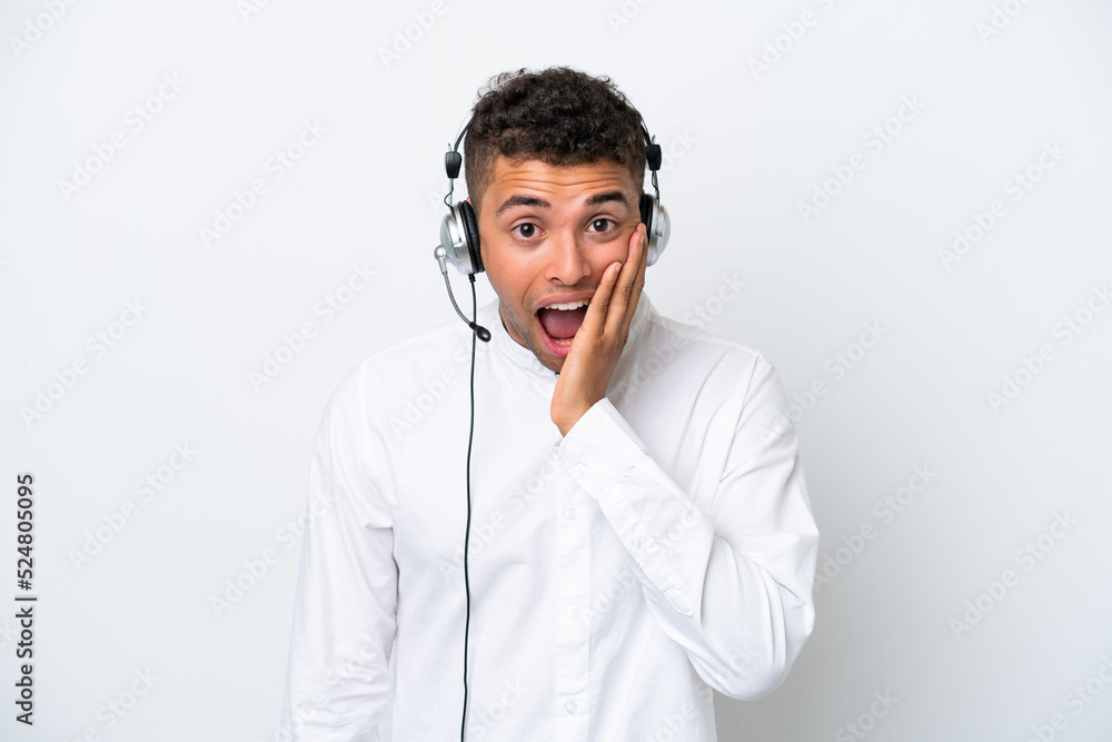 Telemarketer Brazilian man working with a headset isolated on white background with surprise and shocked facial expression Telemarketer Brazilian man working with a headset isolated on white background with surprise and shocked facial expression