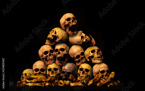 Awesome pile of skull human and bone on wooden, black cloth background, concept of scary crime scene of horror or thriller movies,Halloween theme, Still Life style, selective focus,