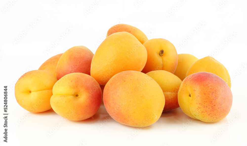 Pile of whole apricots isolated on white background.Ripe sweet fruit Pile of whole apricots isolated on white background.Ripe sweet fruit