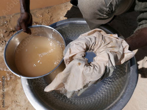 Artisanal miner using mercury to attract gold from ore mixed with water. Mercury is a toxic product that should be handled carefully and that can have a significant impact on health and environment.
