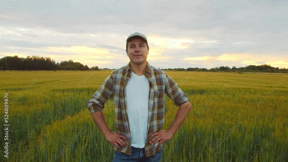 Farmer in front of a sunset agricultural landscape. Man in a countryside field. Country life, food production, farming and country lifestyle concept. Farmer in front of a sunset agricultural landscape. Man in a countryside field. Country life, food production, farming and country lifestyle concept.