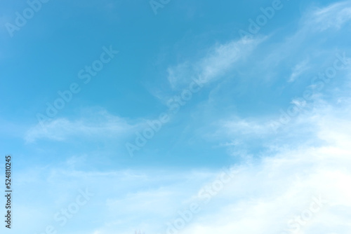 Blue sky with white clouds in sunny day. Beauty clear cloudy sky in sunshine calm air background. Natural background texture, backdrop, wallpaper, element for design © katyamaximenko
