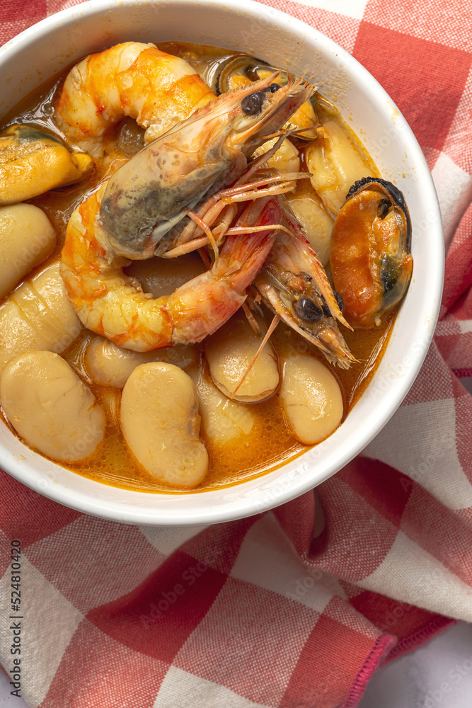 Bowl with typical beans stew with prawns shrimps and mussels Bowl with typical beans stew with prawns shrimps and mussels