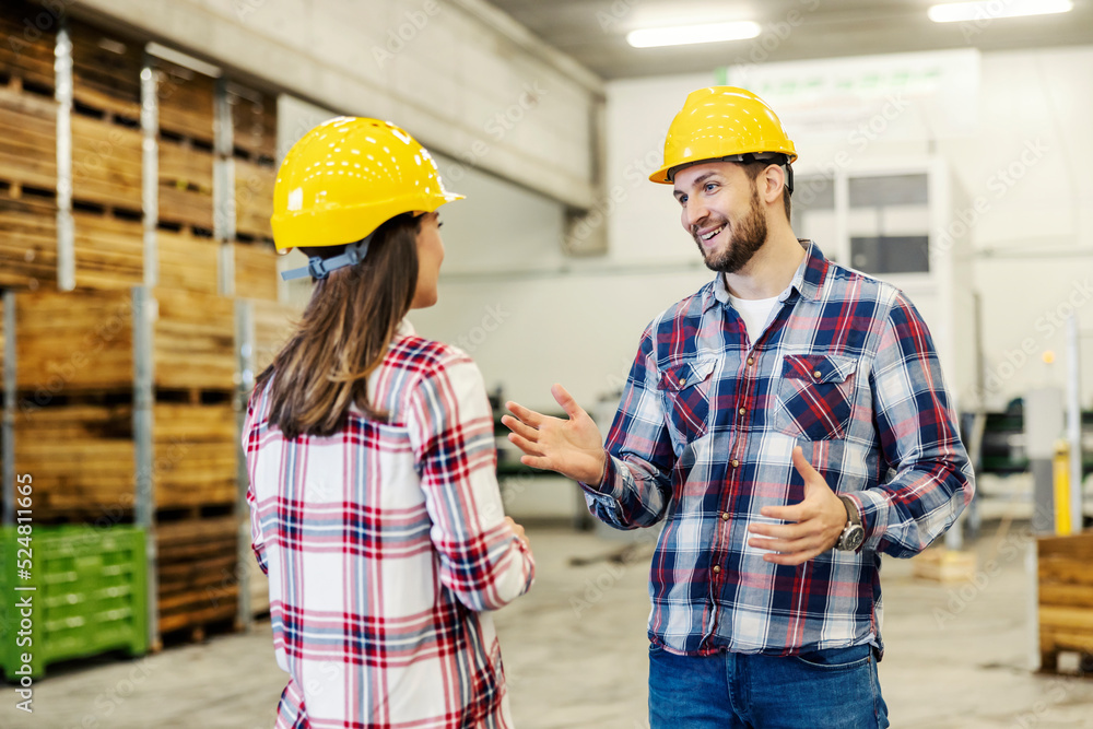 A manager talking to an employee in warehouse. A manager talking to an employee in warehouse.