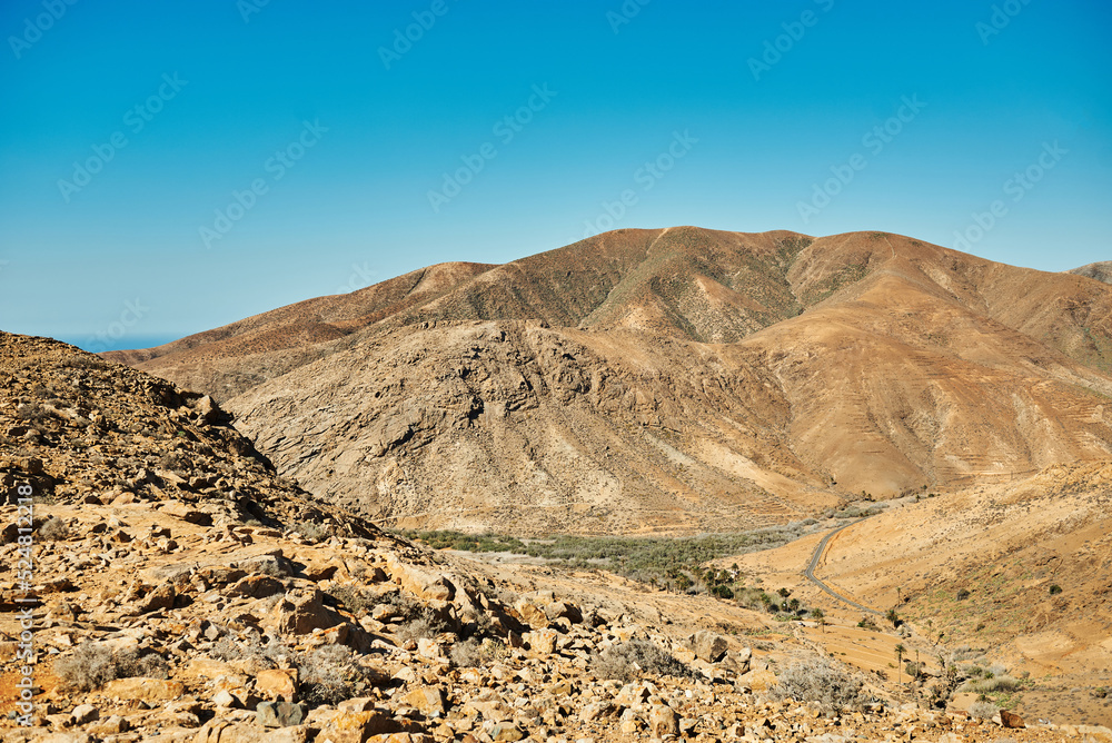 Wavy mountains under blue sky in sunlight Wavy mountains under blue sky in sunlight
