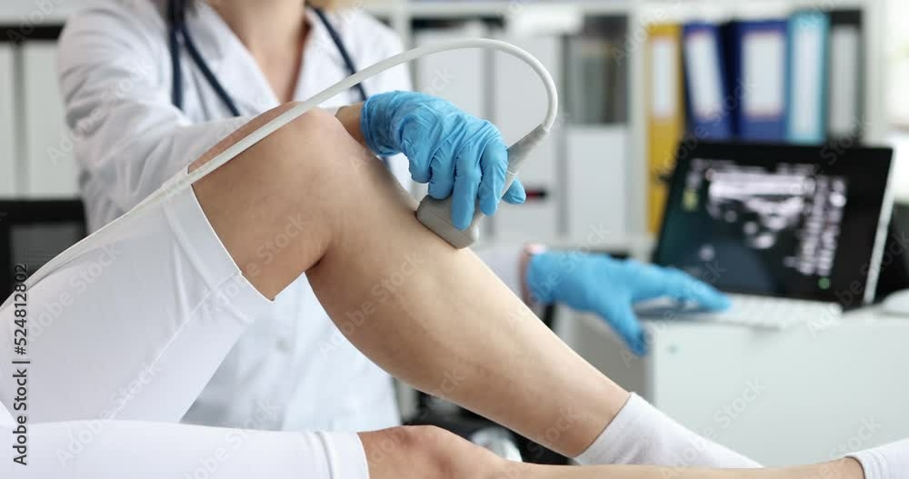 The doctor in the process of ultrasound of the leg, close-up The doctor in the process of ultrasound of the leg, close-up