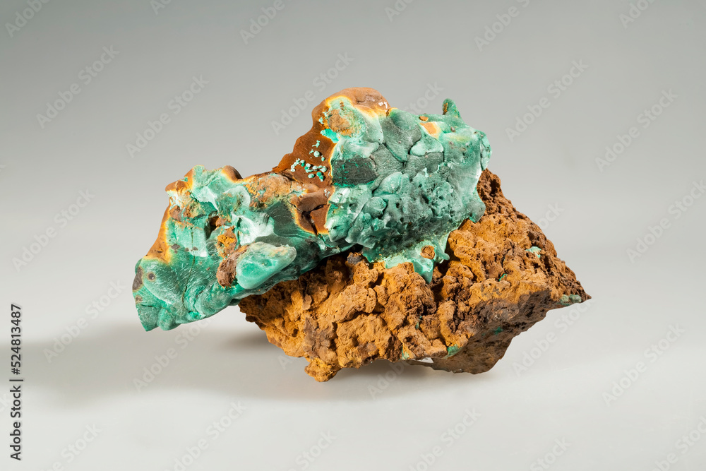 A sample of a natural mineral Malachite (carbonate class) copper carbonate radially radiant aggregate (plate malachite) on lemonite. Museum Mineral Series. Mineralogical sample A sample of a natural mineral Malachite (carbonate class) copper carbonate radially radiant aggregate (plate malachite) on lemonite. Museum Mineral Series. Mineralogical sample