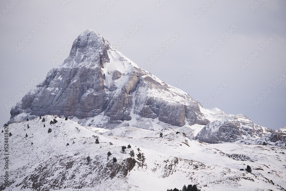 Mountain slope covered with snow under blue sky Mountain slope covered with snow under blue sky