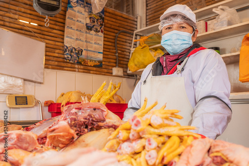 Peruvian woman selling chicken photo