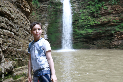 Child in front of Maiden Spit waterfall on Rufabgo stream