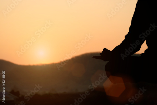 Silhouette of a woman meditating with beautiful nature in the morning sun and mist Calm  Meditation  Relaxation  Spiritual  Mindful 