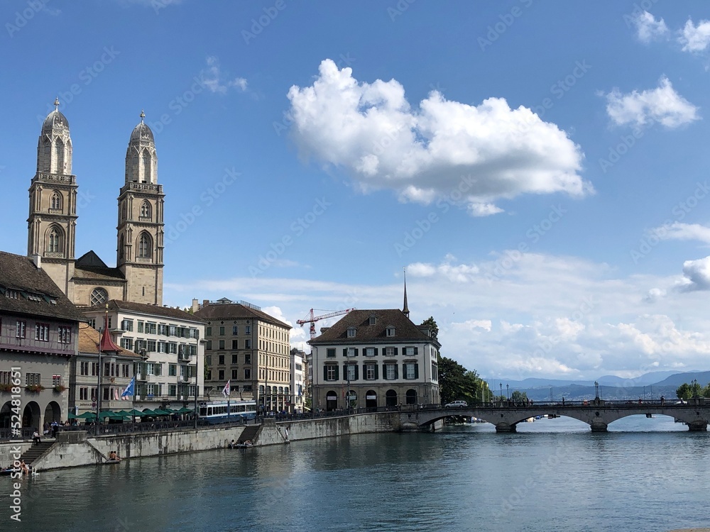 Picturesque city panorama with Grossmünster cathedral, lake and quay, Zurich, Switzerland. Most beautiful Swiss cityscape photos and top Switzerland tourist destinations