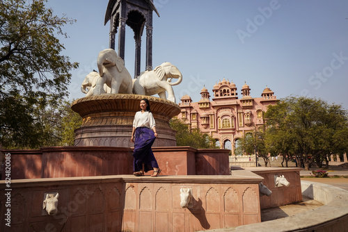 Asian tourist walking on fountain border photo