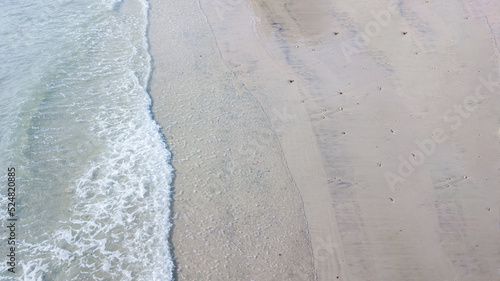 Aerial top view on nature landscape view of dirty tropical sand beach. Aerial top-down drone view.