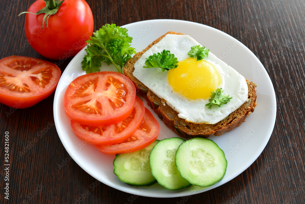 healthy snack with vegetables and sandwich with fried egg, close-up