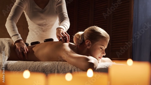 Foto Young, healthy and beautiful woman gets massage therapy in the spa salon