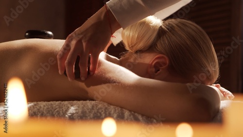 Young, healthy and beautiful woman gets massage therapy in the spa salon. Healthy lifestyle and body care concept.