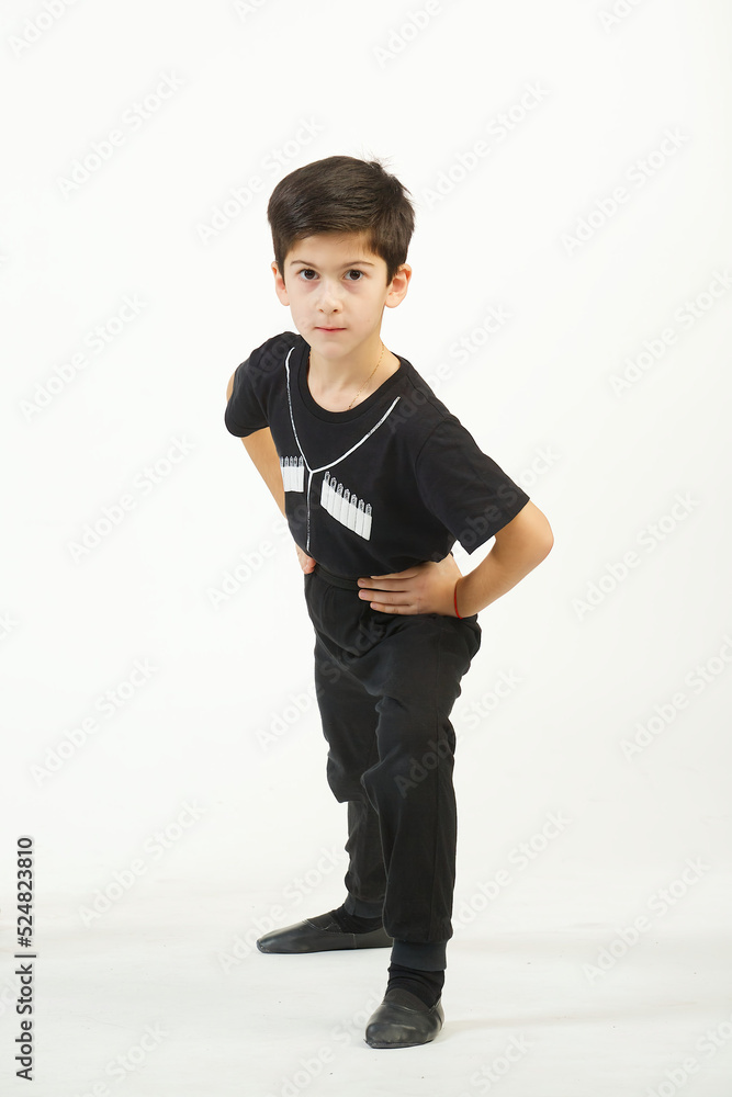 A boy in a national Caucasian outfit in a dancing position on a white background. Traditions, culture and customs of the Eastern peoples. A boy in a national Caucasian outfit in a dancing position on a white background. Traditions, culture and customs of the Eastern peoples.