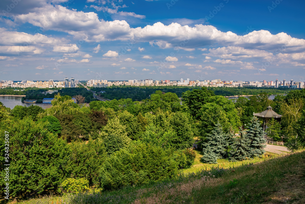 Scenic view on Dnieper hillside in Park of Eternal Glory and left riverside of Dnieper river in Kyiv, Ukraine at sunny summer day Scenic view on Dnieper hillside in Park of Eternal Glory and left riverside of Dnieper river in Kyiv, Ukraine at sunny summer day