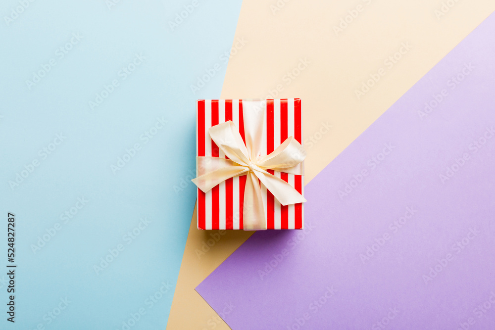 holiday paper present tied yellow ribbon bow top view with copy space. Flat lay holiday background. Birthday or christmas present. Christmas gift box concept with copy space