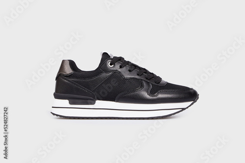 Black sports high soled female basic classic sneaker isolated on white background. Women's footwear, sports shoe, boot, running training basketball shoe. Template, mock up