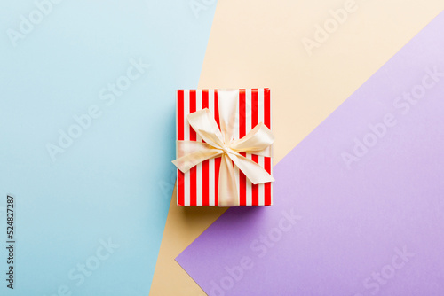 holiday paper present tied yellow ribbon bow top view with copy space. Flat lay holiday background. Birthday or christmas present. Christmas gift box concept with copy space © sosiukin