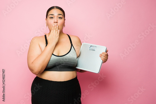Shocked fat woman surprised by her body weight
