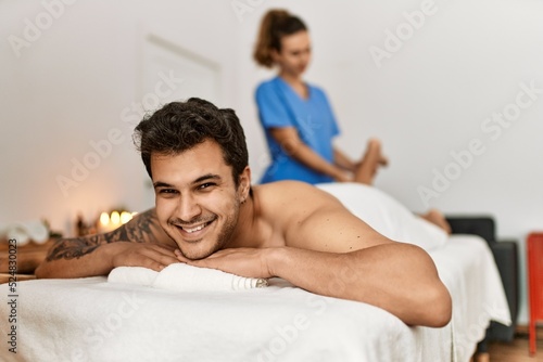 Man smiling happy reciving massage at beauty center.