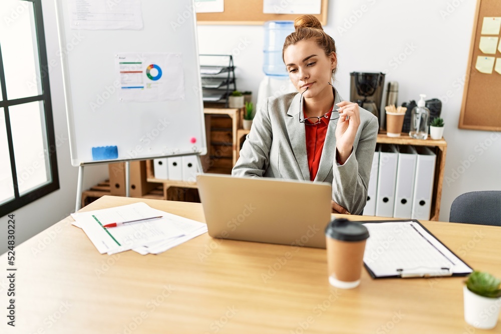 Young woman business worker using laptop working at office Young woman business worker using laptop working at office