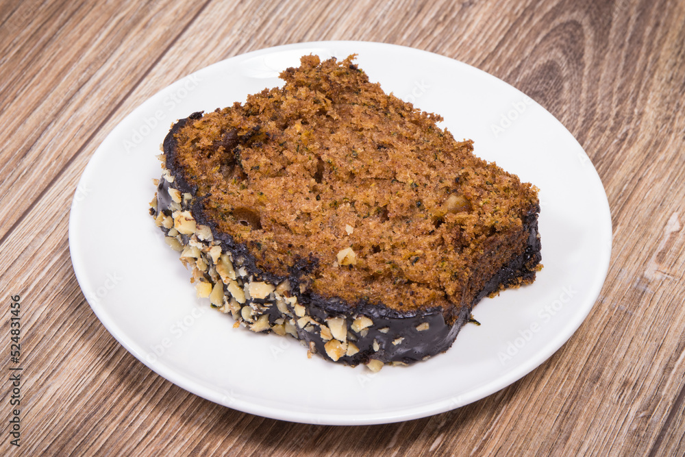 Pastry made of zucchini with nuts and raisin on plate. Delicious dessert Pastry made of zucchini with nuts and raisin on plate. Delicious dessert