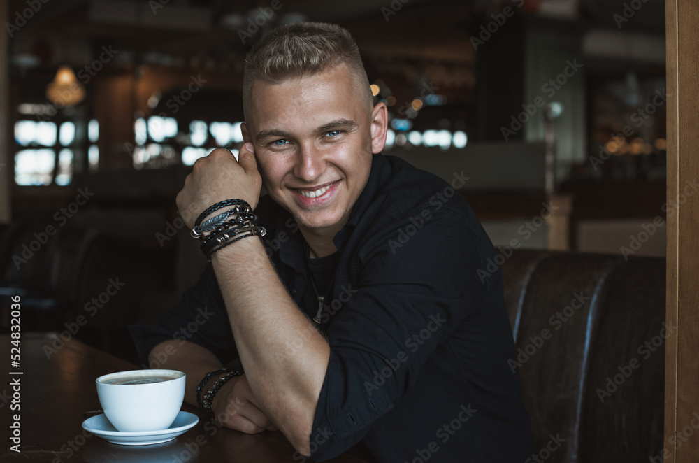Smiling young handsome stylish student, blonde guy, lifestyle of teen- youth life. Portrait of young man