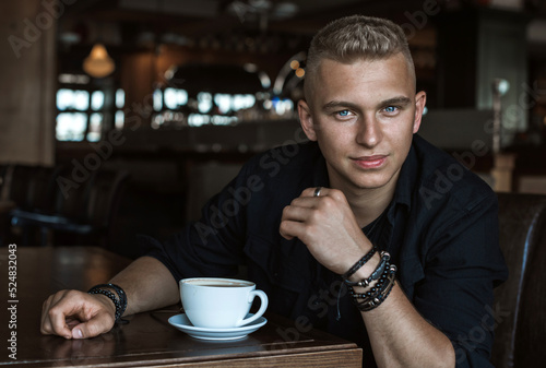 Smiling young handsome stylish student, blonde guy, lifestyle of teen- youth life. Portrait of young man