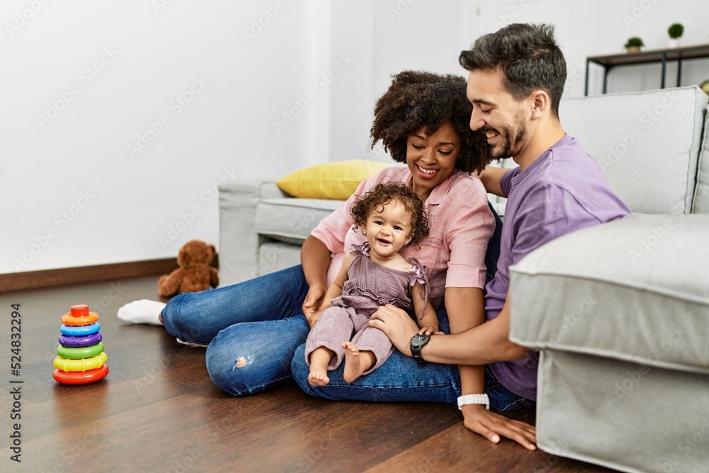 Couple and daughter smiling confident playing with toys sitting on the floor at home Couple and daughter smiling confident playing with toys sitting on the floor at home