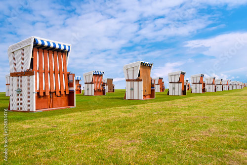 Beach chairs on the Büsum promenade on the North sea coast, Dithmarschen, Schleswig-Holstein, Germany.