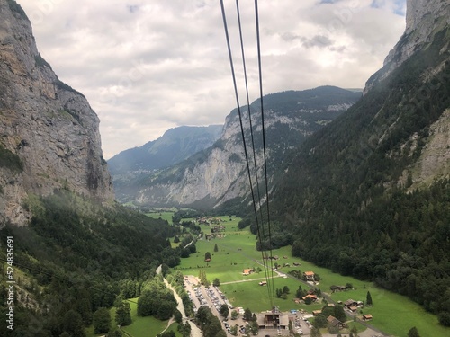 Breathtaking cable car to Stechelberg & Murren, Swiss Alps, Switzerland. Impressive Alpine landscape with mountains, forests and village. Most beautiful and popular Switzerland tourist destinations photo