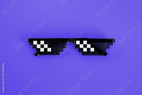 Funny pixelated boss sunglasses on new blue background. Gangster, Black thug life meme glasses . Pixel 8bit style. Color of the Year 2022. Very Peri