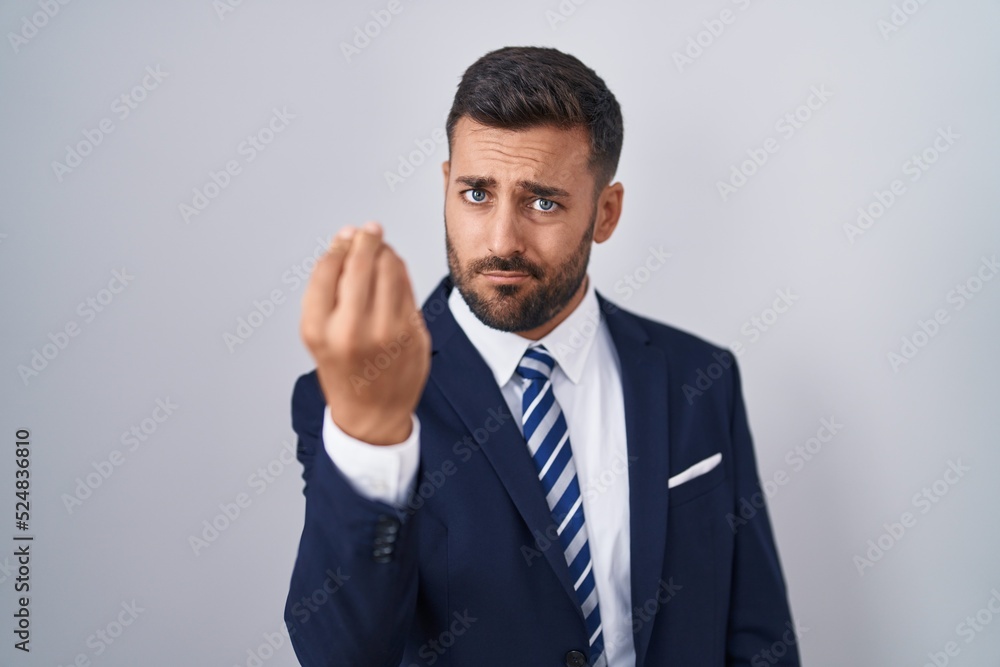 Handsome hispanic man wearing suit and tie doing italian gesture with hand and fingers confident expression Handsome hispanic man wearing suit and tie doing italian gesture with hand and fingers confident expression