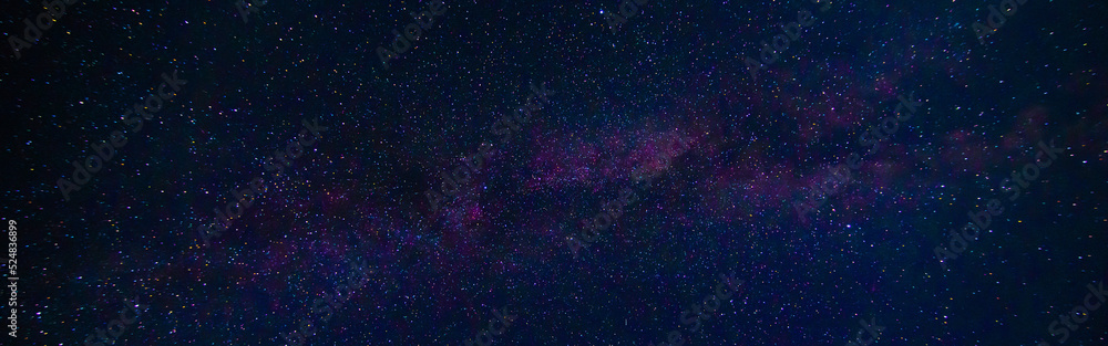 Fototapeta premium Panorama of the night starry sky on the background of the Milky Way with many colorful shining stars
