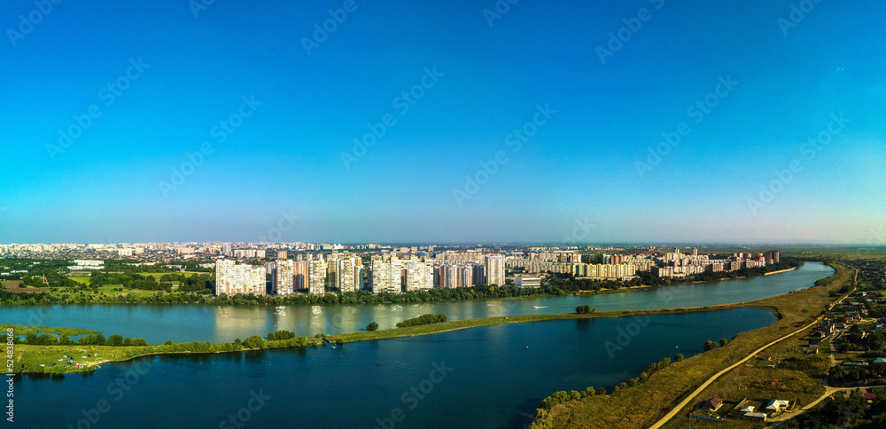 Landscape of the city by the river - the outskirts of the city of Krasnodar (South of Russia) near the Kuban River and Lake Starobzhegokai on a sunny summer day