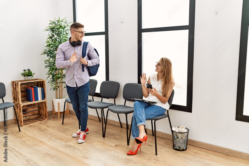 Two hispanic person smiling happy using smartphone at waiting center Two hispanic person smiling happy using smartphone at waiting center