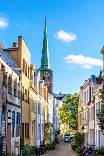 Beautiful facades and view to the tower of St. Jakobi Church in Lübeck, Germany © EKH-Pictures