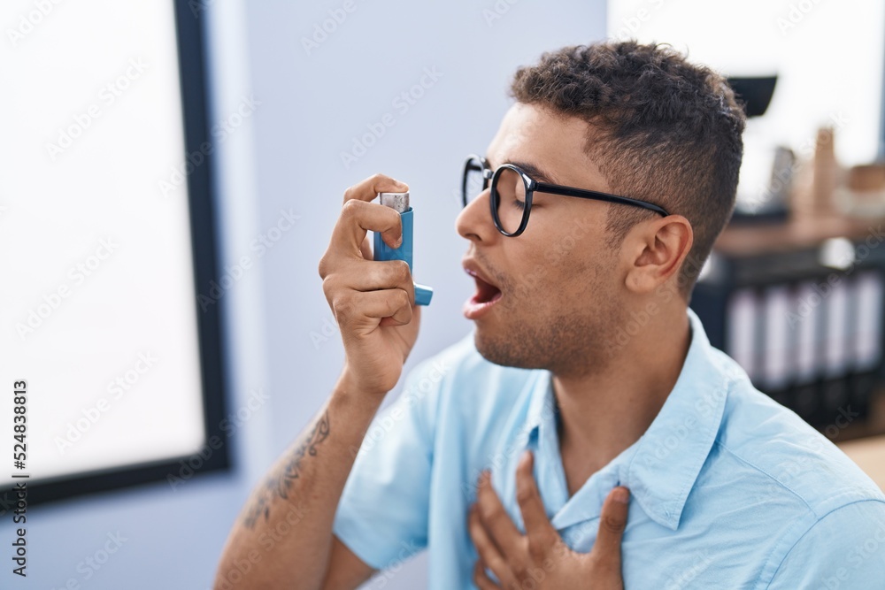 African american man business worker using inhaler at office African american man business worker using inhaler at office