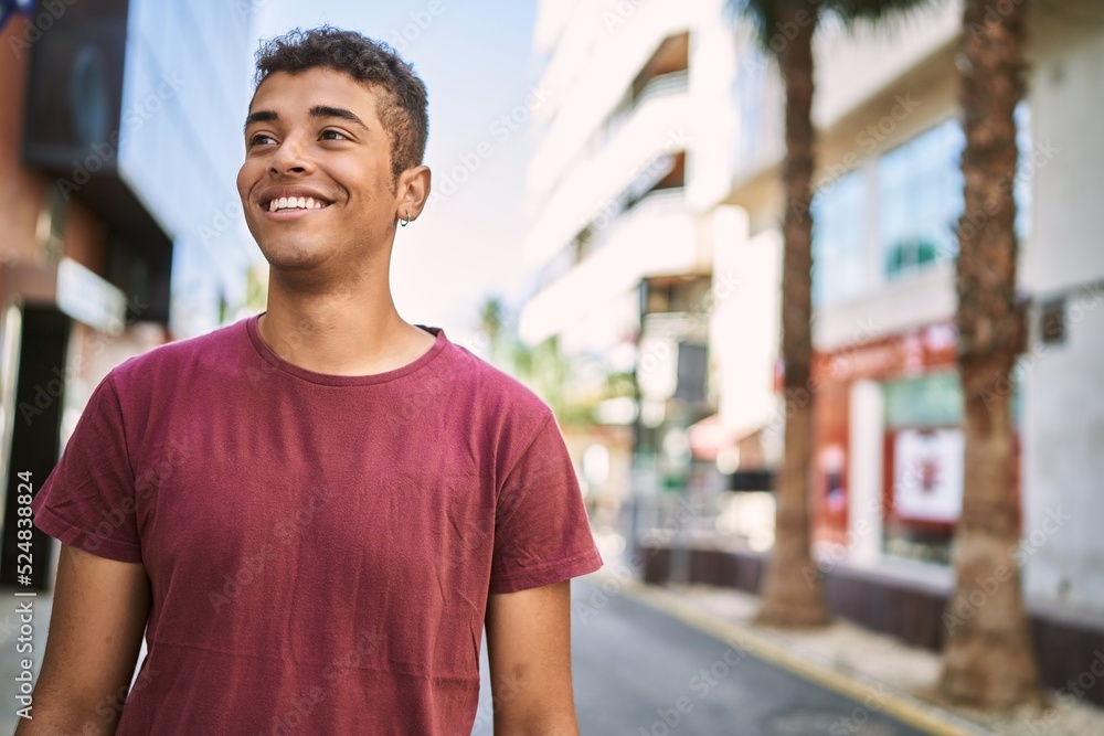 Young latin man smiling happy standing at the city. Young latin man smiling happy standing at the city.