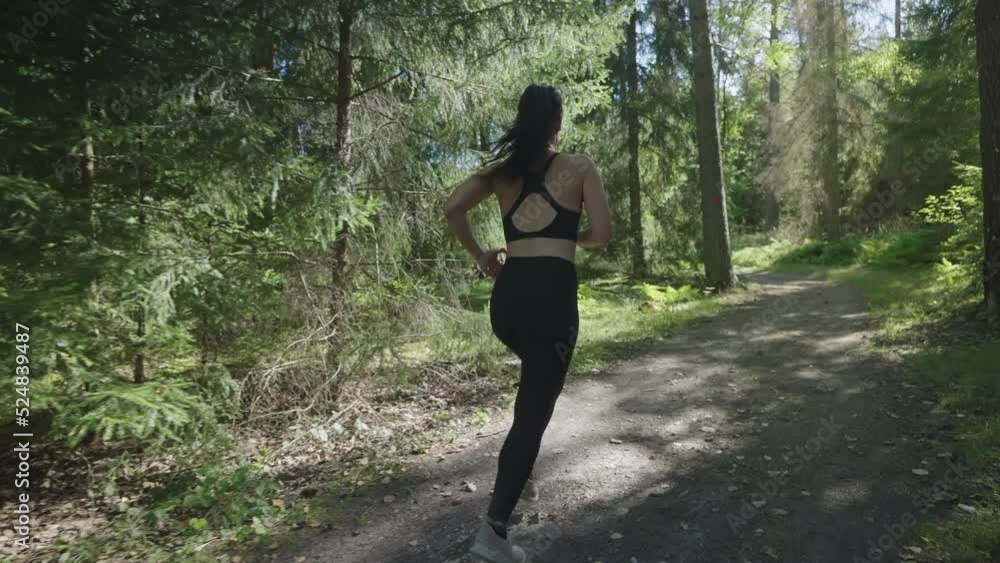 Active Italian woman running on gravel road in nature Active Italian woman running on gravel road in nature