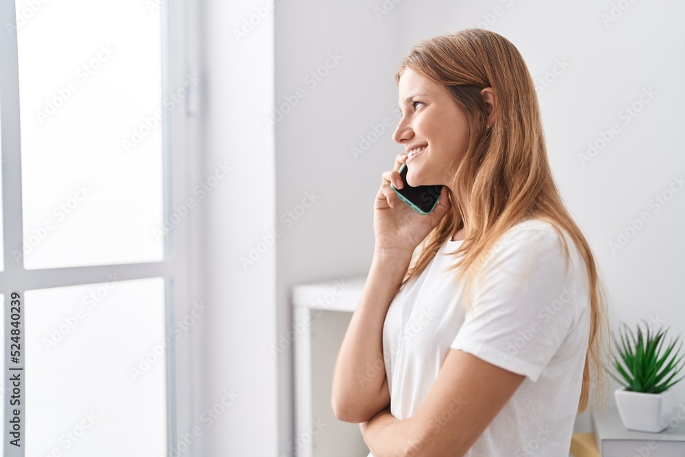 Young blonde girl smiling confident talking on smartphone at home Young blonde girl smiling confident talking on smartphone at home