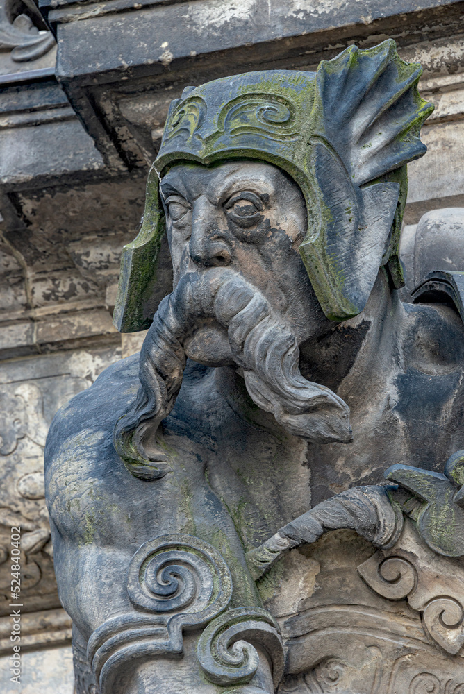 Ancient big statute of scary, fearful and heavy armed gatekeeper, medieval warrior with weapon in historical downtown of Dresden, Germany, details, closeup. Authentic European old architecture. Ancient big statute of scary, fearful and heavy armed gatekeeper, medieval warrior with weapon in historical downtown of Dresden, Germany, details, closeup. Authentic European old architecture.