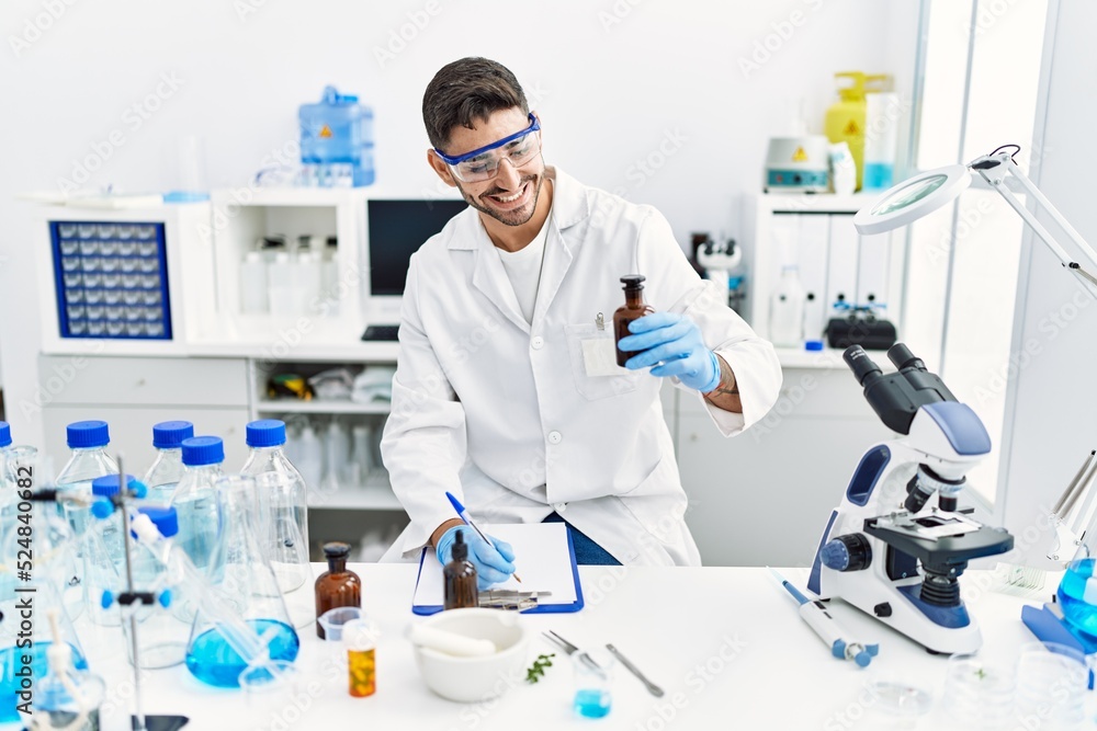 Handsome hispanic man working as scientific at laboratory Handsome hispanic man working as scientific at laboratory