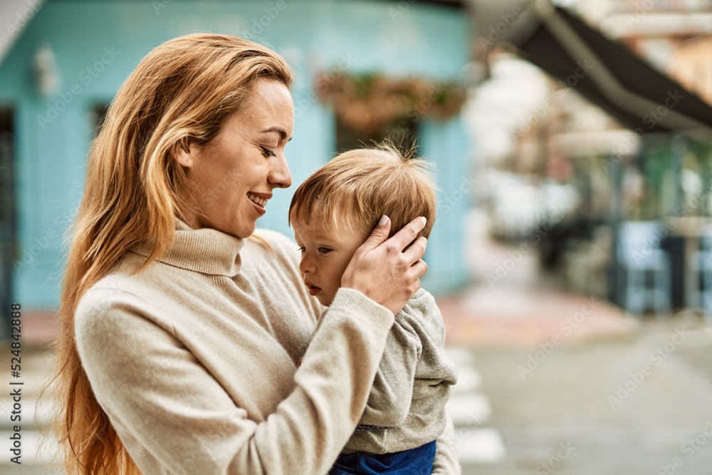 Beautiful family of mother and baby son hugging and bonding together with love. Parent and toddler outdoors Beautiful family of mother and baby son hugging and bonding together with love. Parent and toddler outdoors