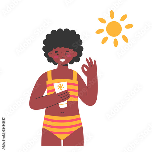Dark skinned girl using sunscreen on the beach 